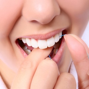 Woman Flossing Her Teeth